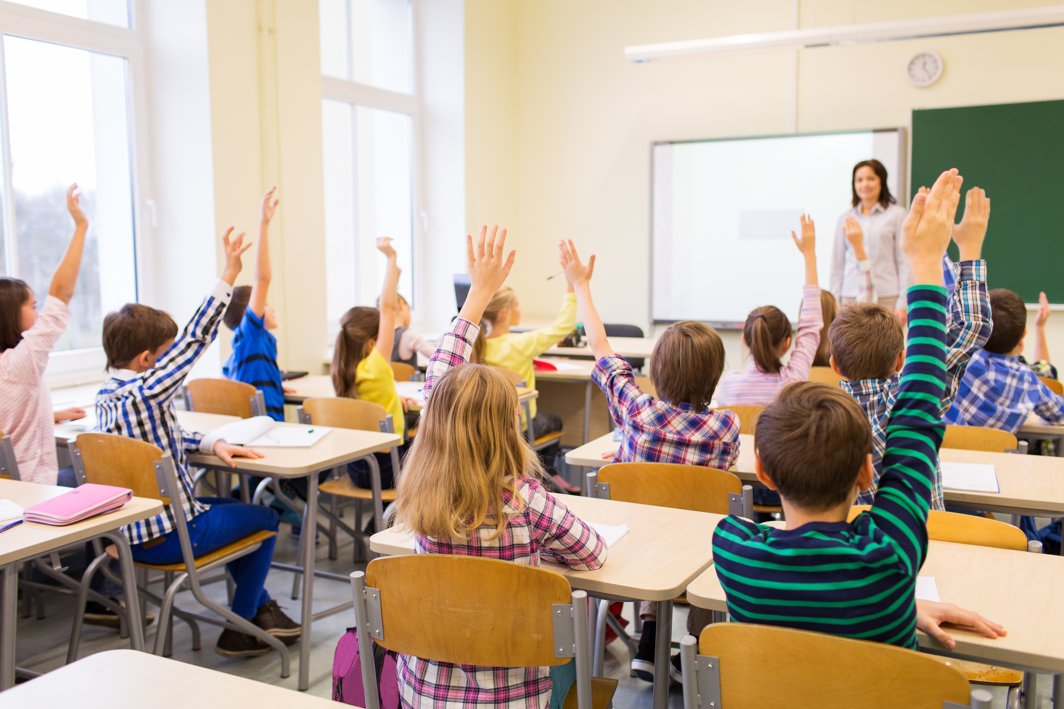 © Syda Productions | Dreamstime.com - Group of school kids raising hands in classroom
